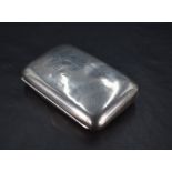 A late Victorian silver cigarette case, of hinged rectangular form, curved for the gentleman's