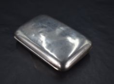 A late Victorian silver cigarette case, of hinged rectangular form, curved for the gentleman's