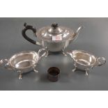 A George V silver three piece teaset, comprising a teapot, sugar and cream, each of oval form with