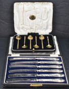 A cased set of six George V silver gilt coffee spoons, with engraved stylised decoration to