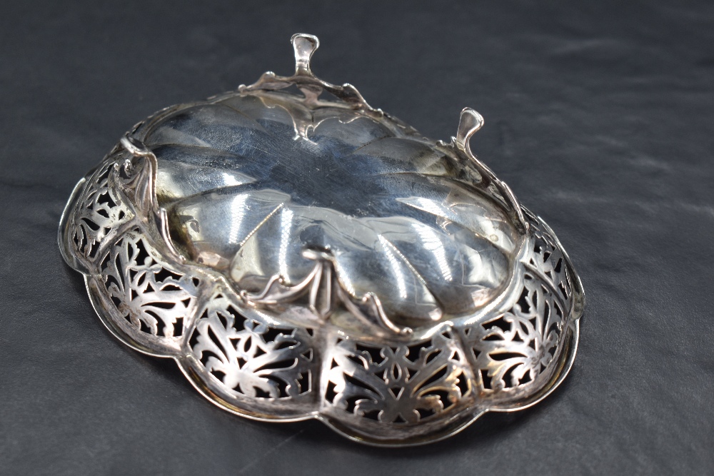 A small George V silver dish, of lobed and fluted oval form with foliate pierced border, raised on - Image 2 of 2
