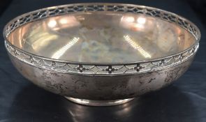 A George V silver dish, of circular form with stylised pierced rim and short moulded circular