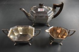 A George V silver three-piece teaset, of canted rectangular form, with angular handles and
