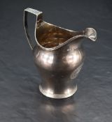 A George III silver milk jug, of helmet form with angular reeded handle, reeded rim and foot,