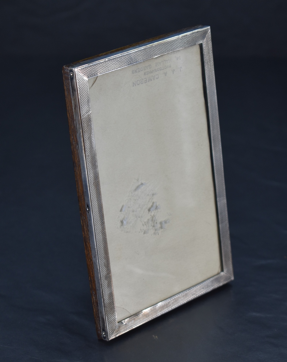A George V silver photograph frame, of rectangular form with engine-turned decoration, marks for