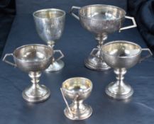 A group of five Golfing related silver trophies, various designs, ages and makers, gross weight