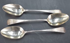 A group of three Georgian silver table spoons, Old English pattern with pip reverse, two engraved