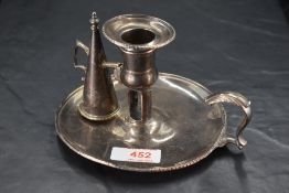 A George III silver chamber stick, of traditional design with removable sconce, conical extinguisher