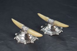 A pair of Edwardian silver and Mother-of-Pearl knife rests, the shaped Mother-of-Pearl platforms
