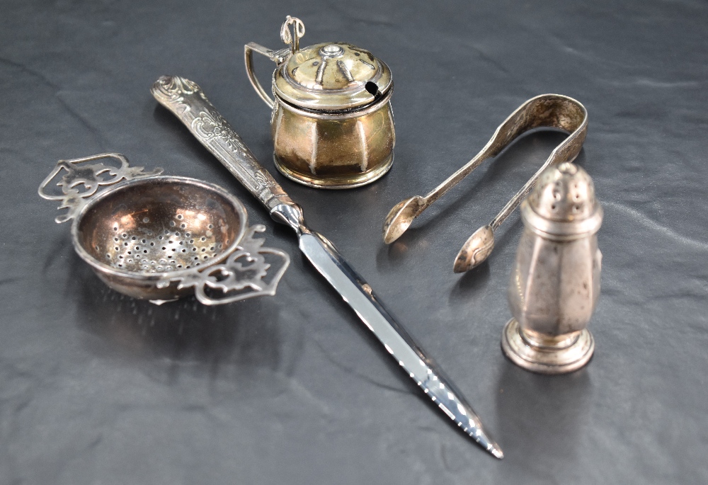 A George V silver tea strainer, of pierced circular form with ornate pierced handles, marks for