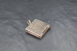 A late Victorian silver stamp case, of square form with vine leaf engraved decoration and slide