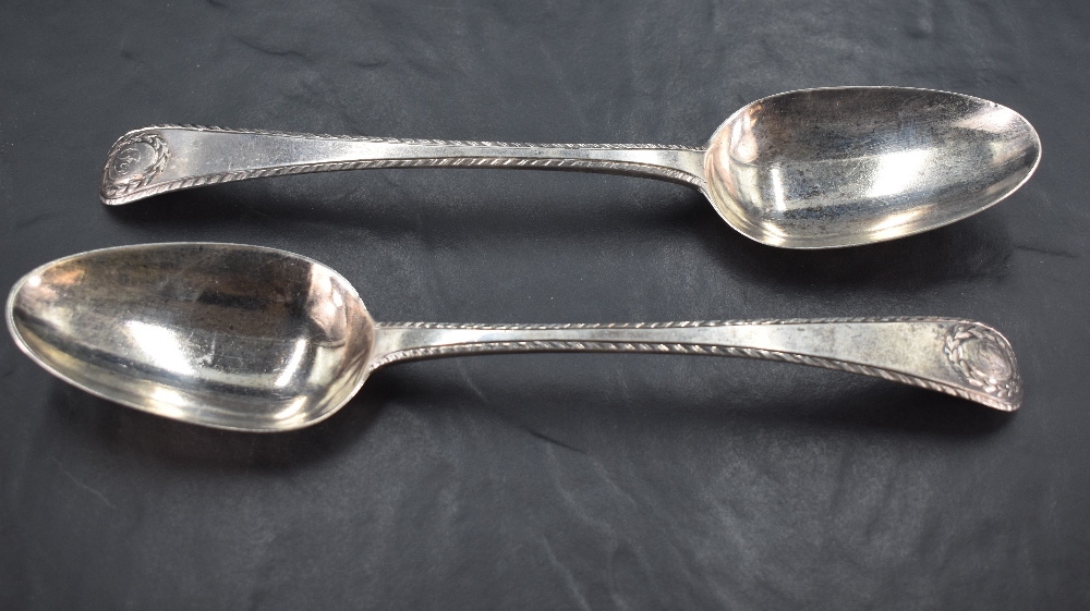 A pair of George II silver serving spoons, Old English pattern with gadrooned edge detail and oval