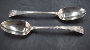 A pair of George II silver serving spoons, Old English pattern with gadrooned edge detail and oval