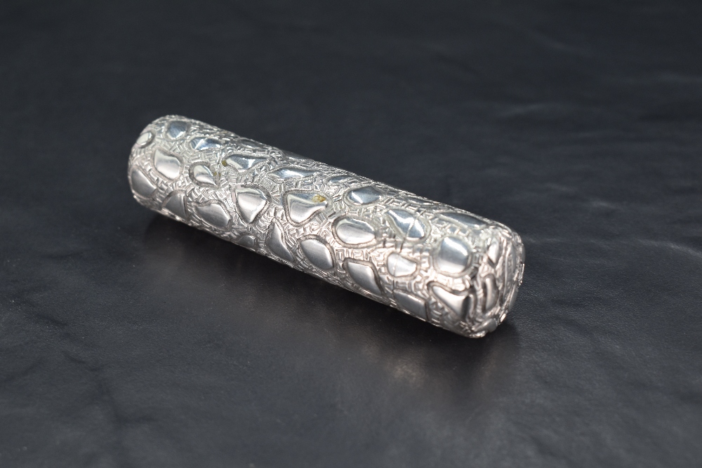 A Victorian silver double-ended scent bottle, of cylindrical form with embossed stylised decoration,