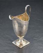A William IV silver cream jug, of elongated helmet form with shallow spout and looped strap handle