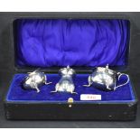 A George VI silver three-piece condiment set, comprising pepperette, salt and mustard, the latter