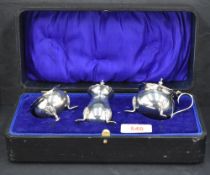 A George VI silver three-piece condiment set, comprising pepperette, salt and mustard, the latter