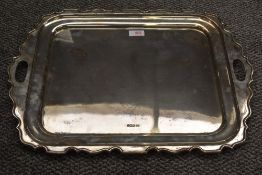 A George V silver two-handled tray, of rounded and dished rectangular form with Chippendale