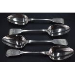 A group of four 19th century silver fiddle pattern table spoons, engraved stags head crest to