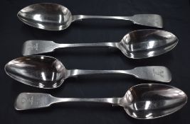 A group of four 19th century silver fiddle pattern table spoons, engraved stags head crest to