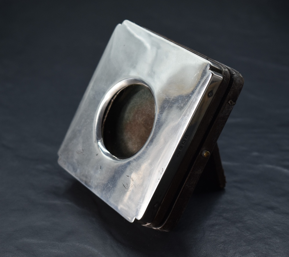 A George V silver mounted watch holder, of hinged square form with re-entrant corners, opening by - Image 2 of 2