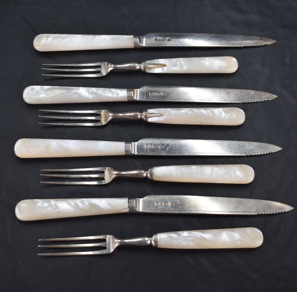 A group of George V Mother-of-Pearl handled silver dessert cutlery, comprising four three tined