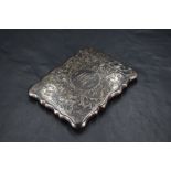 An Edwardian silver visiting card case, of hinged rectangular form with shaped outline and profuse