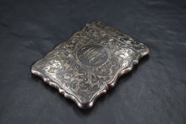 An Edwardian silver visiting card case, of hinged rectangular form with shaped outline and profuse