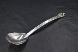 An unusual Queen Elizabeth II silver spoon, having an ovoid bowl, the plain shaped stem surmounted