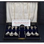 A cased set of silver teaspoons and matching sugar tongs, each with twisted stems and figural