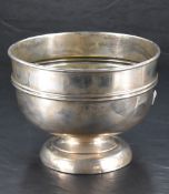 A George V silver bowl, of plain form with moulded central band, marks for Birmingham 1911, makers
