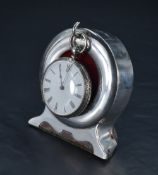 An Edwardian silver mounted pocket watch stand, of circular form with suspension hook and stylised