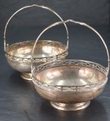 A pair of George V silver baskets,of circular form with stylised pierced rim, pierced and shaped