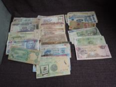 A collection of used World Banknotes including India, China, Vietnam, Romania, Malaysia, Mexico,