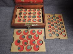 A wooden lockable case containing three trays of Roman Coins and one Hammered Coin, 60 in total