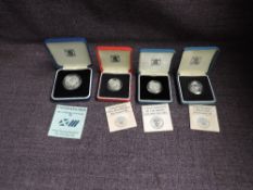 Three Royal Mint Silver Proof Coins, 1986 £1, 1985 £1, Piedfort 1986 £1 and a Royal Mint 1986 Silver
