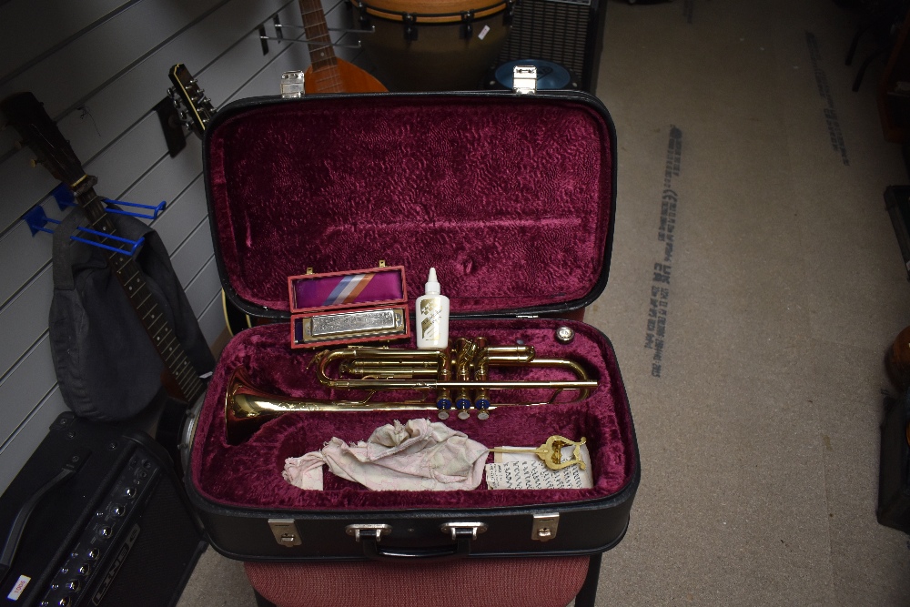 A Corton trumpet in fitted case and a vintage Hohner harmonica