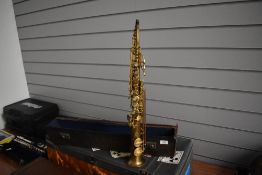 An early 20th Century CG Conn, Elkhart soprano saxophone, serial number M184091, also has agents
