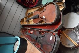 Two antique violins and cases, with one bow, all as found