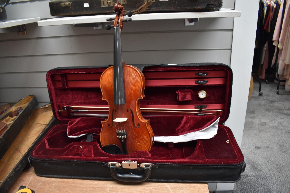 A modern violin having one piece 14inch back , labelled Bellolino, with plush fitted case and bow