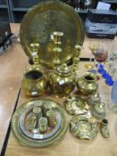 A selection of brass ware, including Indian Lassi cups, charger with traditional Indian scenes,