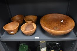 A large elm turned wood fruit bowl, diameter 32cm, together with four smaller examples