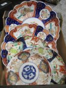 Five 20th century oriental plates in varying Imari hues, having scalloped edges, some having