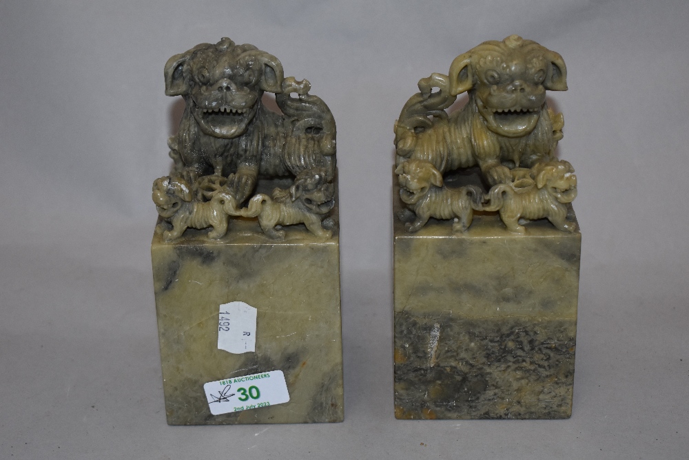 Two Chinese carved soap stone book ends, each depicting five Foo dogs.