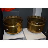 Two large vintage brass planters having hammered finish and scalloped edges.