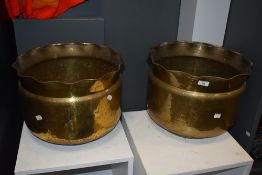 Two large vintage brass planters having hammered finish and scalloped edges.