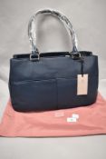 A Radley Canning Town blue leather handbag and pink drawstring fabric bag