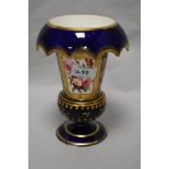 A 19th century footed vase with down turned cuffed neck, having cobalt blue ground and floral