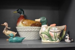 A novelty duck tea pot or jug, a egg basket of duck form and three similar ornaments.
