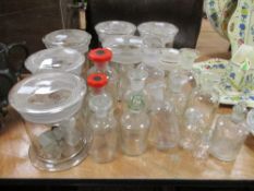 A selection of vintage glass storage jars and scientific/pharmacy bottles.